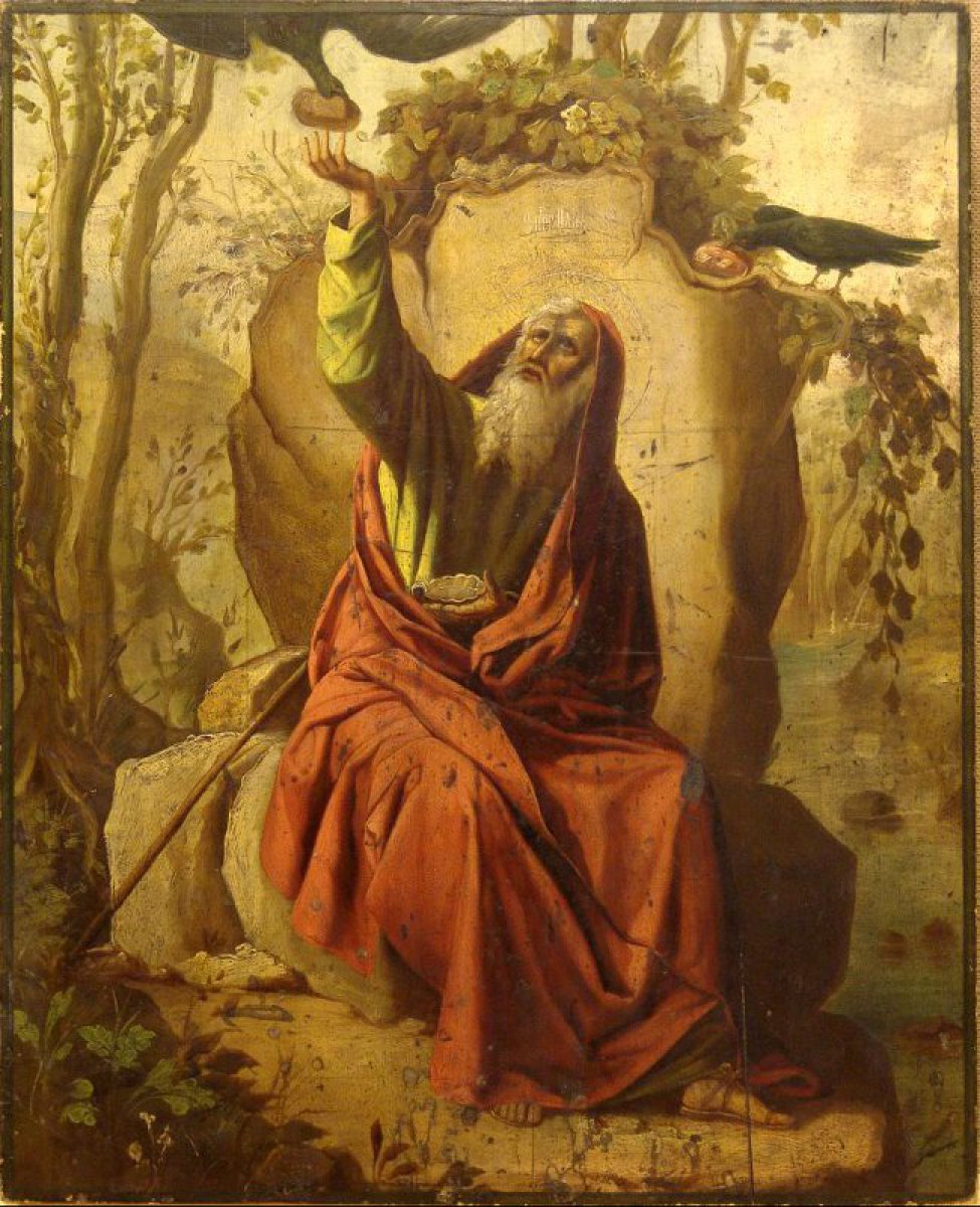 Доска: Икона с выемкой, двумя врезными шпонками.
Изображен Илья-пророк, сидящий у скалы в красной верхней и зеленой нижней одеждах, правая рука поднята кверху, и ворон в нее опускает хлеб. Слева и справа пейзаж с рекой.