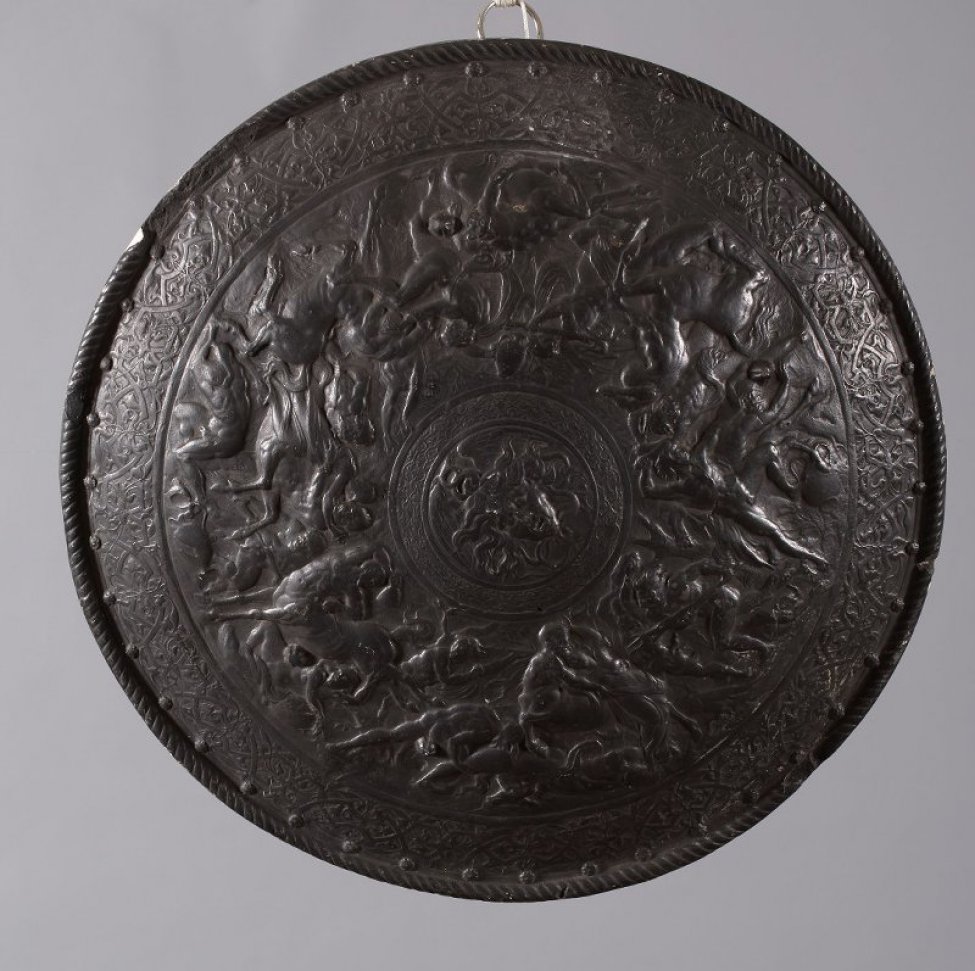 Барельеф на круглом щите изображает битву людей с центаврами. В центре щита - голова Медузы. Поверхность щита выпуклая с лицевой стороны, по окружности у края орнамент.