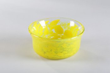 ваза из прозрачного стекла с желтыми пятнами-брызгами, цилиндрической формы, с округлым основанием и расширенным верхом.