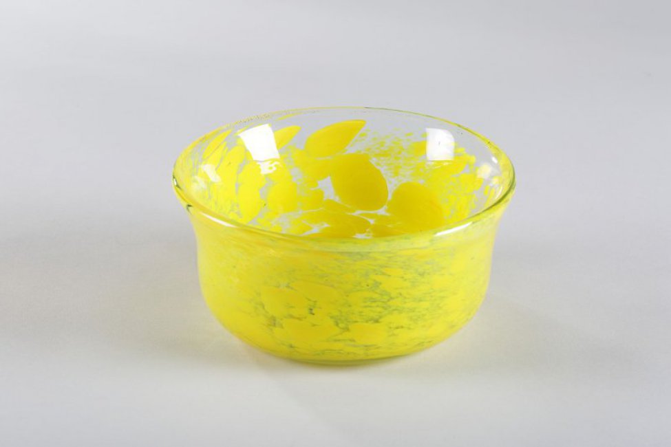ваза из прозрачного стекла с желтыми пятнами-брызгами, цилиндрической формы, с округлым основанием и расширенным верхом.