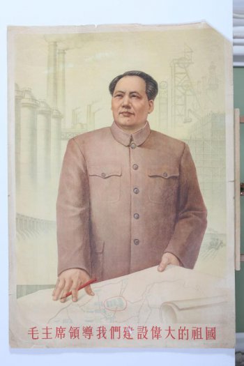 Изображен Мао Цзе-дун  на фоне заводов у карты строительства заводов, один из которых  обведен красным кружком.
