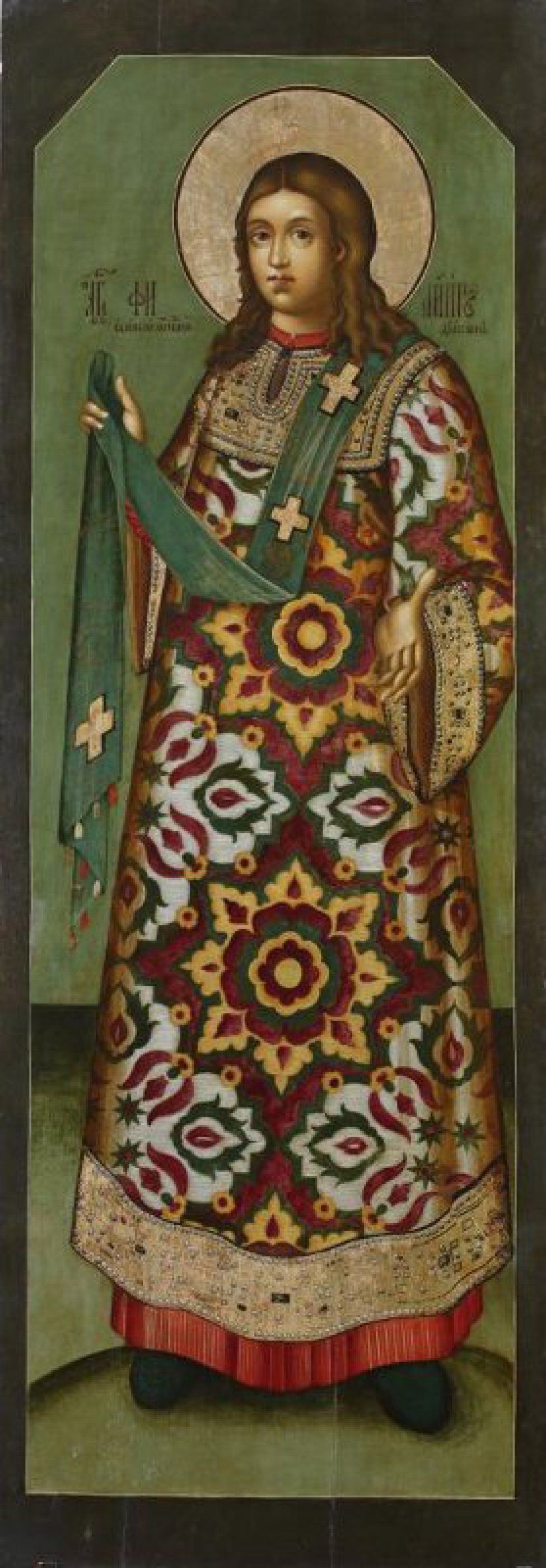Доска: Доска без ковчега с 2 врезными односторонними шпонками.
Святой изображен в рост, с длинными, до плеч, волосами и в цветистой одежде с крупным орнаментом. Фон зеленый, край темный.