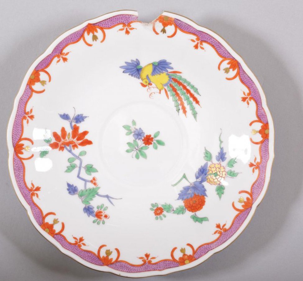 Блюдце с волнистым, ребристым бортом, сиреневой каймой и позолотой по краю. На зеркале стилизованная цветочная роспись с фигуркой фазана.